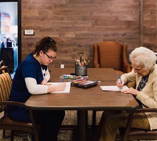 Pelican Landing staff coloring with resident